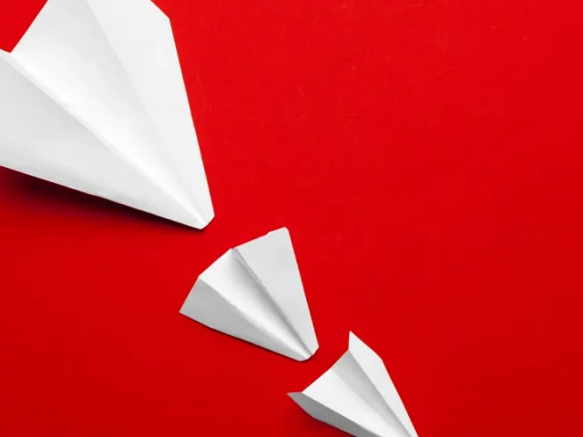 white-paper-airplane-on-a-red-background-2022-01-07-17-04-41-utc