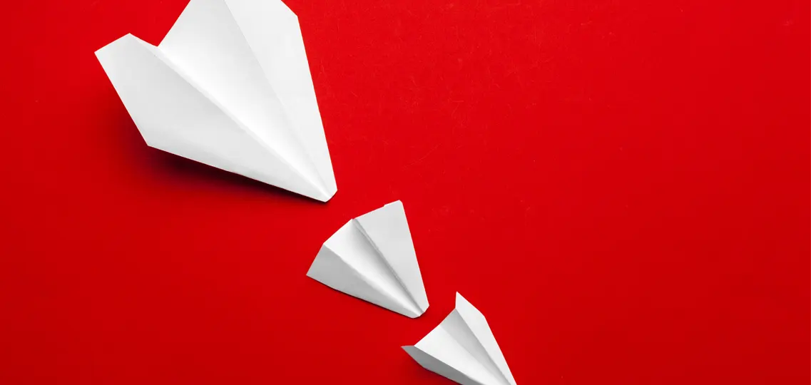 white-paper-airplane-on-a-red-background-2022-01-07-17-04-41-utc